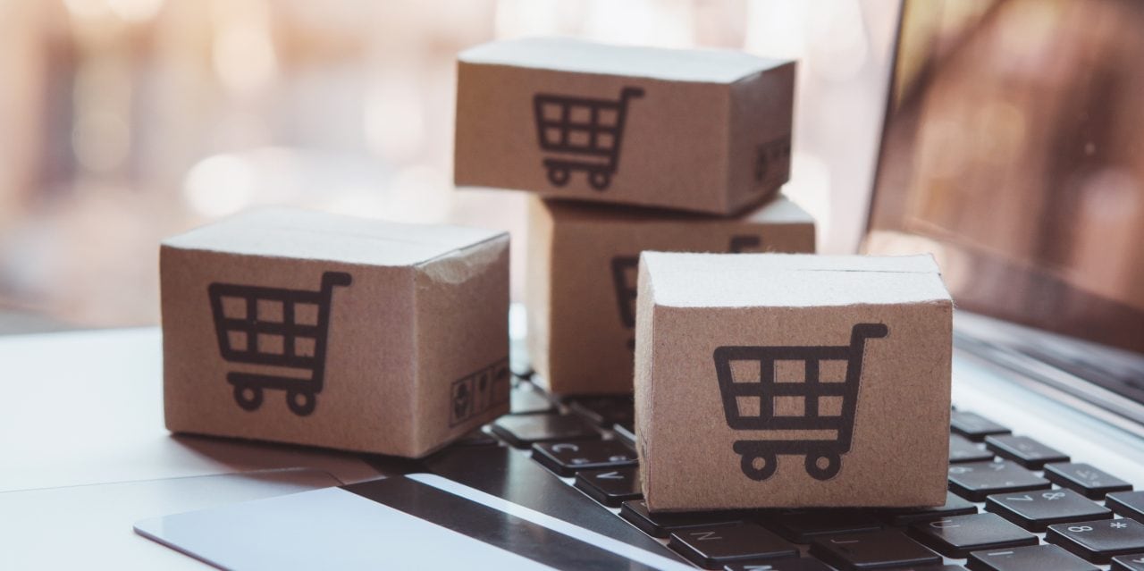 1939658200 Shopping online. Credit card and cardboard box with a shopping cart logo on laptop keyboard. Shopping service on The online web. offers home delivery